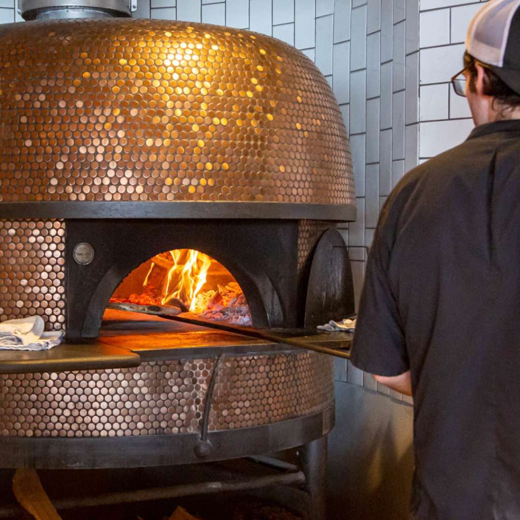Oakfire cooking up comfort food favorites in their wood-fired pizza oven